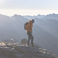 Hiker at the top of a mountain peak