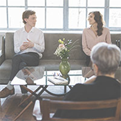 A couple meeting with a therapists and receiving counseling